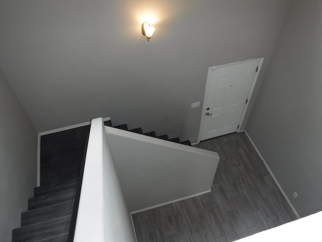 stairs with wood finished floors and baseboards