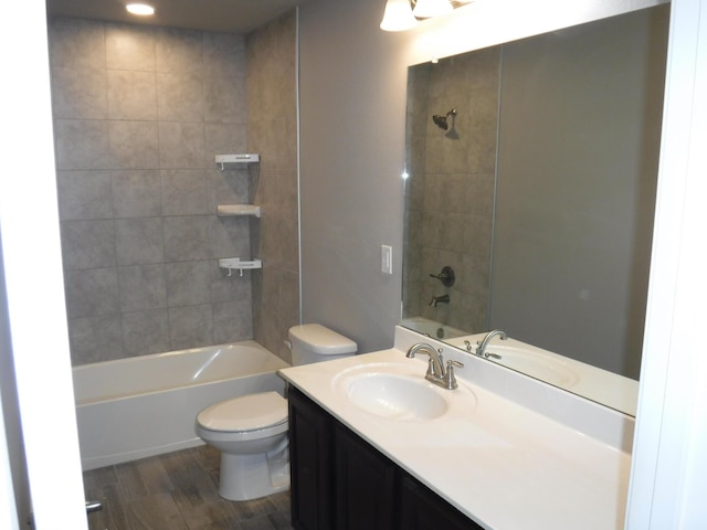 bathroom featuring shower / bath combination, wood finished floors, vanity, and toilet