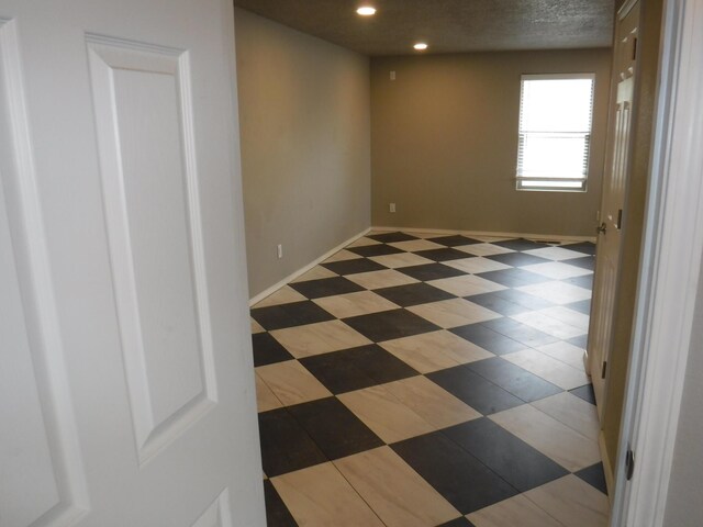 unfurnished room featuring recessed lighting and baseboards