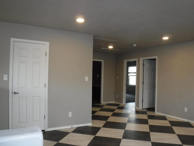 spare room with baseboards, tile patterned floors, and recessed lighting