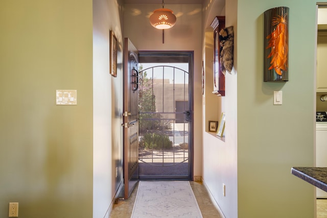 doorway to outside featuring baseboards