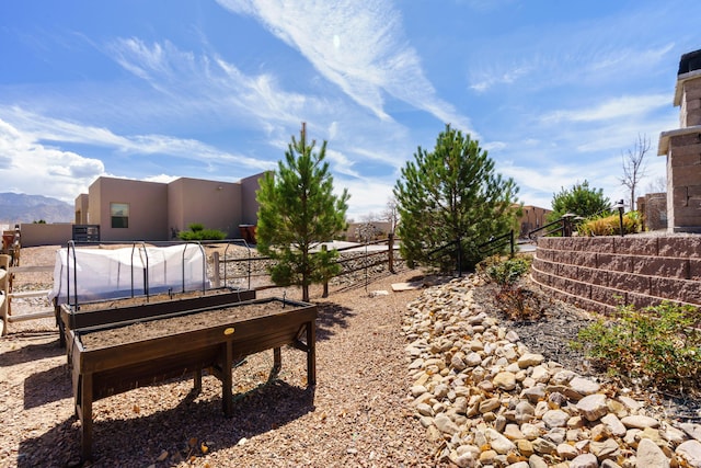 view of yard with a vegetable garden and fence