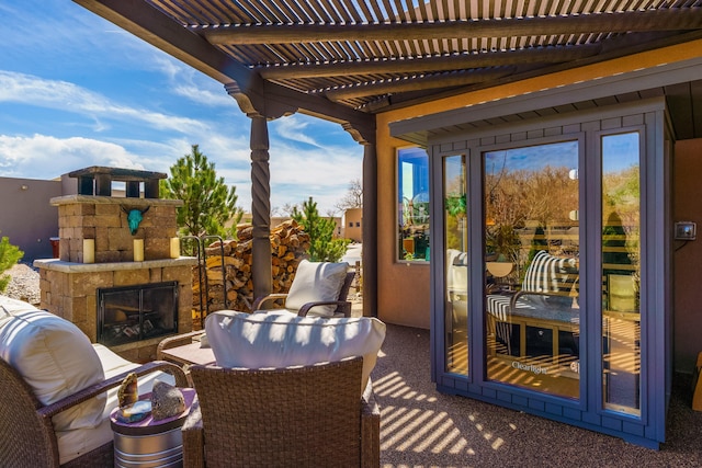 view of patio with a pergola and an outdoor stone fireplace
