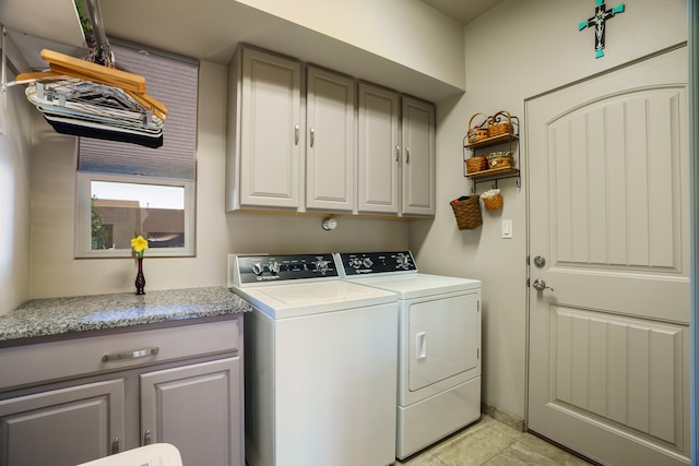 laundry room featuring washing machine and dryer and cabinet space