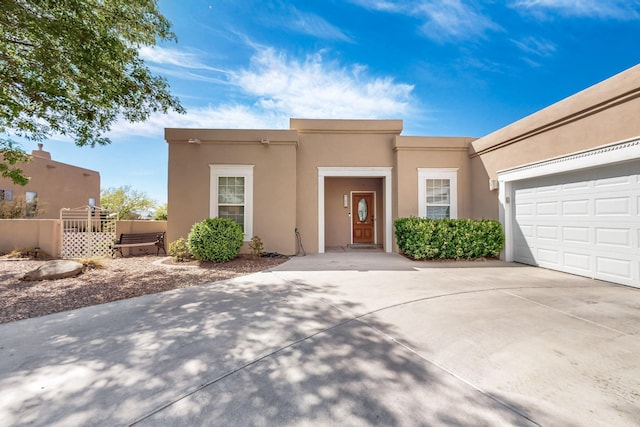 4104 Killington Rd NW, Albuquerque, NM 87114 - southwest-style home with stucco siding, concrete driveway, and an attached garage