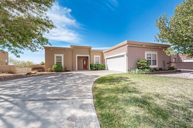 4104 Killington Rd NW, Albuquerque, NM 87114 - pueblo-style home featuring stucco siding, a garage, and concrete driveway