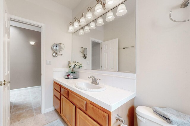 4104 Killington Rd NW, Albuquerque, NM 87114 - bathroom with vanity, toilet, and backsplash