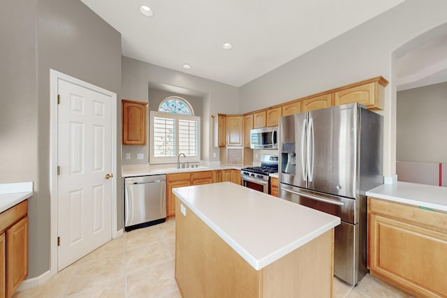 4104 Killington Rd NW, Albuquerque, NM 87114 - kitchen with stainless steel appliances, a center island, a sink, light countertops, and light brown cabinetry