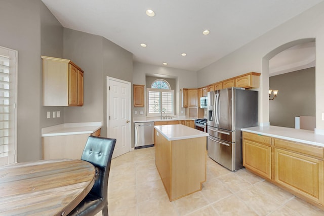 4104 Killington Rd NW, Albuquerque, NM 87114 - kitchen with appliances with stainless steel finishes, a sink, a center island, arched walkways, and recessed lighting