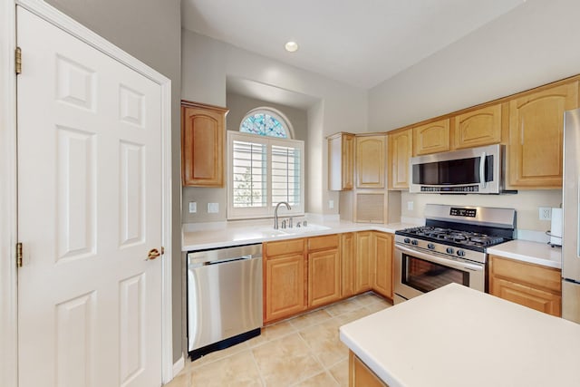 4104 Killington Rd NW, Albuquerque, NM 87114 - kitchen with appliances with stainless steel finishes, a sink, light tile patterned floors, and light brown cabinets