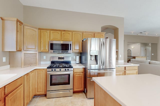 4104 Killington Rd NW, Albuquerque, NM 87114 - kitchen with appliances with stainless steel finishes, light brown cabinets, open floor plan, light tile patterned flooring, and light countertops