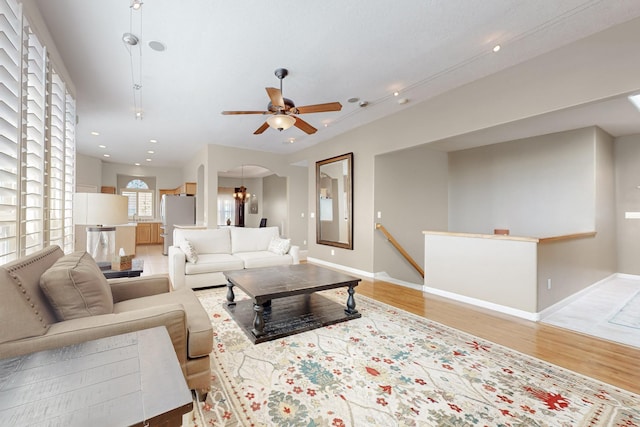 4104 Killington Rd NW, Albuquerque, NM 87114 - living room featuring light wood-style flooring, recessed lighting, a ceiling fan, arched walkways, and baseboards