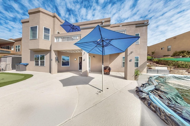 4104 Killington Rd NW, Albuquerque, NM 87114 - rear view of house featuring a putting area, a patio area, and stucco siding