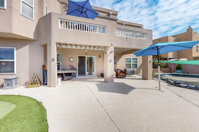 4104 Killington Rd NW, Albuquerque, NM 87114 - rear view of property featuring a patio area, stucco siding, and a balcony