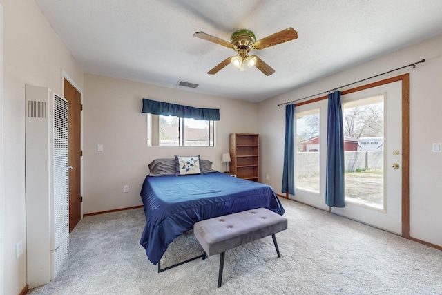 5208 Simon Dr NW, Albuquerque, NM 87114 - bedroom featuring visible vents, a heating unit, light carpet, access to exterior, and baseboards