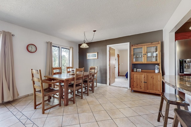 5208 Simon Dr NW, Albuquerque, NM 87114 - dining area featuring a textured ceiling, baseboards, and light tile patterned flooring