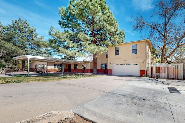 5208 Simon Dr NW, Albuquerque, NM 87114 - view of front of house featuring an attached garage, brick siding, stucco siding, a gate, and concrete driveway