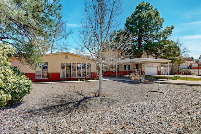 5208 Simon Dr NW, Albuquerque, NM 87114 - ranch-style house featuring brick siding, a garage, stucco siding, and driveway