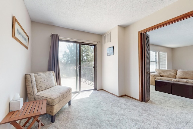5208 Simon Dr NW, Albuquerque, NM 87114 - living area with a textured ceiling, visible vents, a healthy amount of sunlight, and carpet