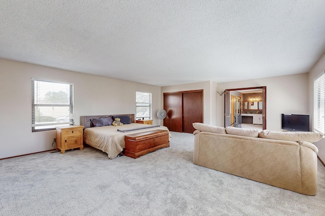5208 Simon Dr NW, Albuquerque, NM 87114 - carpeted bedroom with multiple windows, a closet, and a textured ceiling