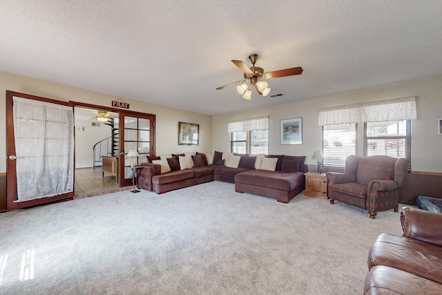 5208 Simon Dr NW, Albuquerque, NM 87114 - carpeted living room with stairway, a ceiling fan, a textured ceiling, and visible vents