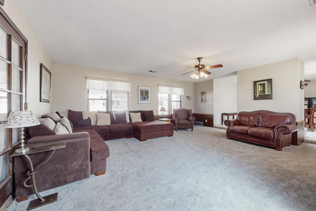 5208 Simon Dr NW, Albuquerque, NM 87114 - carpeted living area featuring ceiling fan, a textured ceiling, and visible vents