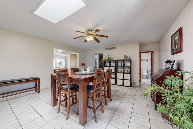 5208 Simon Dr NW, Albuquerque, NM 87114 - dining room with visible vents, a ceiling fan, and light tile patterned floors