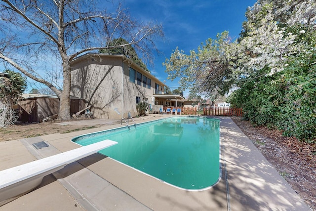 5208 Simon Dr NW, Albuquerque, NM 87114 - view of pool with a diving board, a fenced in pool, a fenced backyard, and a patio area