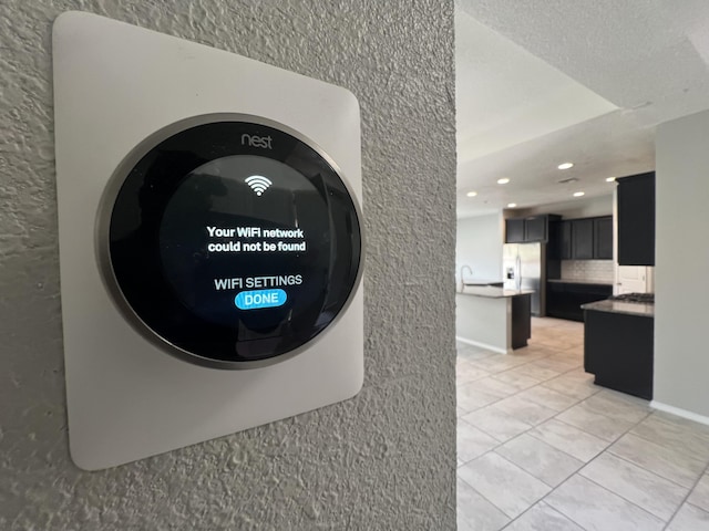 6016 N Sandia Ct, Rio Rancho, NM 87144 - detailed view of recessed lighting, decorative backsplash, and stainless steel refrigerator with ice dispenser