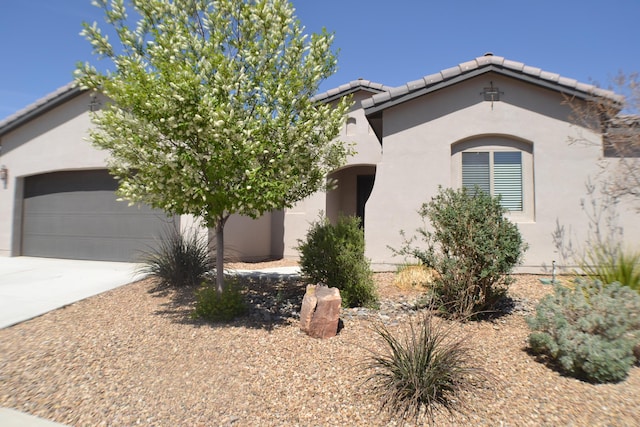 6016 N Sandia Ct, Rio Rancho, NM 87144 - view of front facade with stucco siding, concrete driveway, an attached garage, and a tile roof