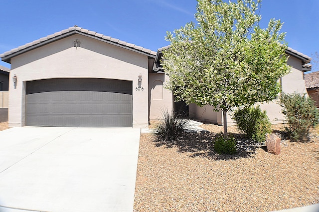 6016 N Sandia Ct, Rio Rancho, NM 87144 - view of front facade featuring stucco siding, an attached garage, concrete driveway, and a tiled roof