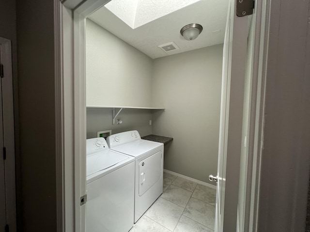 6016 N Sandia Ct, Rio Rancho, NM 87144 - washroom with a skylight, washer and dryer, and baseboards