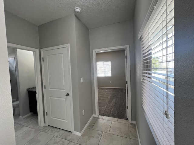 6016 N Sandia Ct, Rio Rancho, NM 87144 - hallway featuring baseboards and a textured ceiling