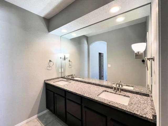 6016 N Sandia Ct, Rio Rancho, NM 87144 - full bathroom with baseboards, double vanity, recessed lighting, and tile patterned floors