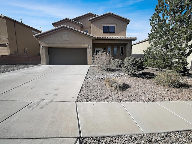 7110 Wasilla Dr NE, Rio Rancho, NM 87144 - view of front of property featuring stucco siding, an attached garage, a tiled roof, and concrete driveway