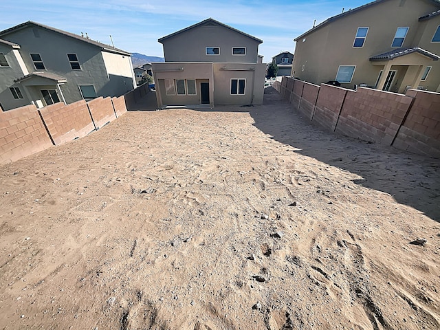7110 Wasilla Dr NE, Rio Rancho, NM 87144 - rear view of property with a fenced backyard and stucco siding
