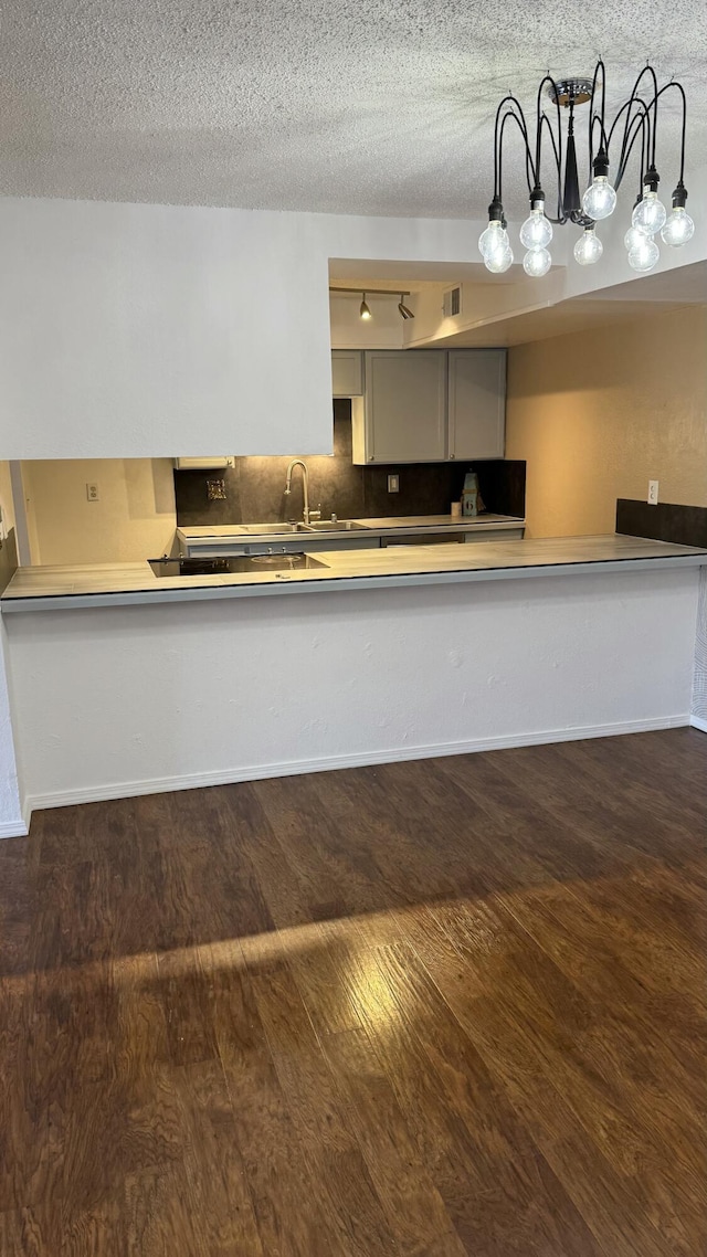 3839 Montgomery Blvd NE Unit 724, Albuquerque, NM 87109 - kitchen featuring a sink, a textured ceiling, and wood finished floors