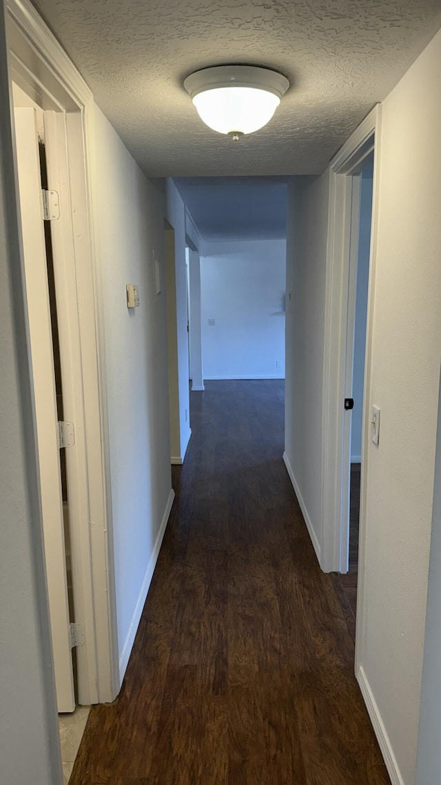3839 Montgomery Blvd NE Unit 724, Albuquerque, NM 87109 - hall with baseboards, a textured ceiling, and wood finished floors