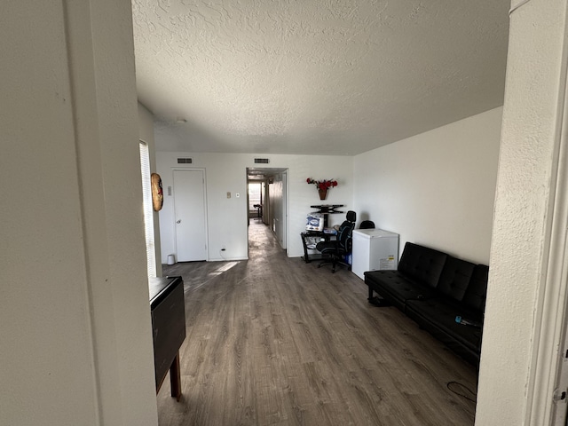 4601 Carlisle Blvd NE Unit E1, Albuquerque, NM 87109 - living area with visible vents, a textured ceiling, and wood finished floors
