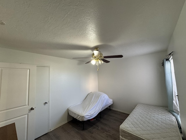 4601 Carlisle Blvd NE Unit E1, Albuquerque, NM 87109 - bedroom with a textured ceiling, dark wood-style floors, and a ceiling fan