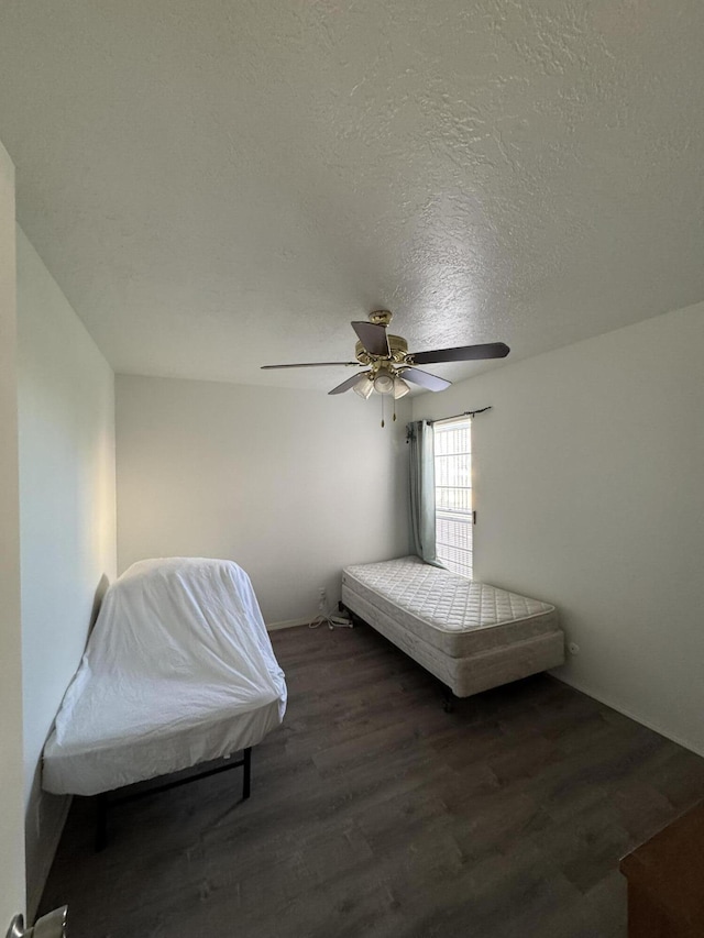 4601 Carlisle Blvd NE Unit E1, Albuquerque, NM 87109 - bedroom with a textured ceiling, wood finished floors, and ceiling fan