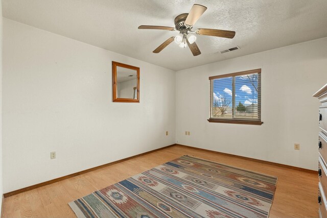 69 Midway Rd, Lemitar, NM 87823 - spare room with light wood finished floors, a ceiling fan, baseboards, and a textured ceiling