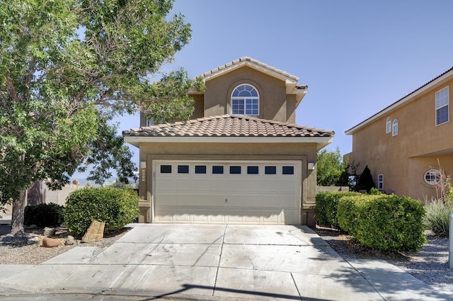 4844 Stafford Pl NW, Albuquerque, NM 87120 - mediterranean / spanish house with stucco siding, driveway, a garage, and a tiled roof