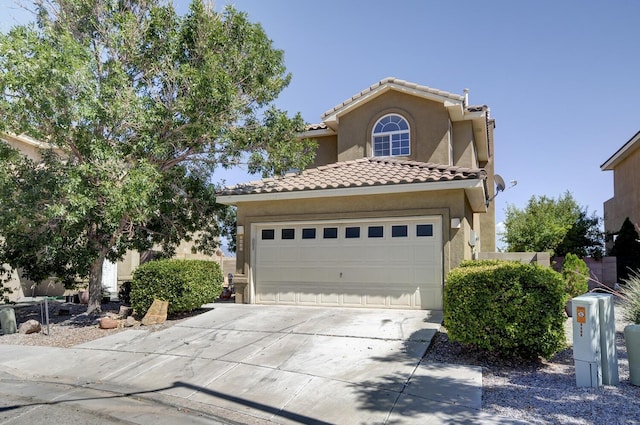 4844 Stafford Pl NW, Albuquerque, NM 87120 - mediterranean / spanish home featuring a tile roof, stucco siding, driveway, and a garage