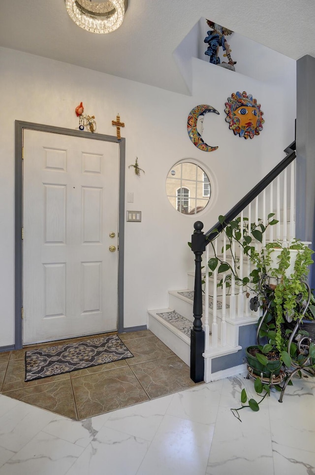 4844 Stafford Pl NW, Albuquerque, NM 87120 - foyer entrance featuring marble finish floor, baseboards, and stairway