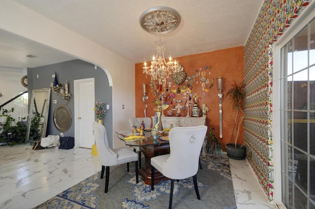 4844 Stafford Pl NW, Albuquerque, NM 87120 - dining room with marble finish floor, arched walkways, a chandelier, and visible vents