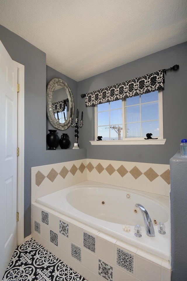 4844 Stafford Pl NW, Albuquerque, NM 87120 - bathroom featuring a tub with jets, tile patterned flooring, and a textured ceiling