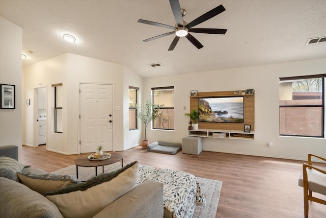 6624 Conrad Ave NW, Albuquerque, NM 87120 - living room with lofted ceiling, wood finished floors, visible vents, and ceiling fan