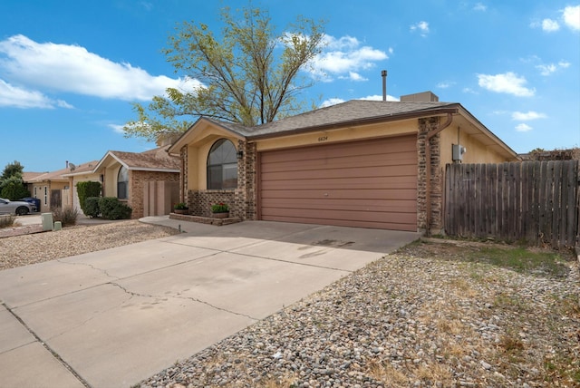 6624 Conrad Ave NW, Albuquerque, NM 87120 - single story home with an attached garage, driveway, fence, and brick siding