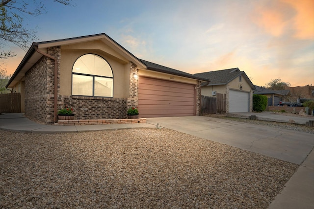 6624 Conrad Ave NW, Albuquerque, NM 87120 - ranch-style house featuring brick siding, an attached garage, fence, and driveway